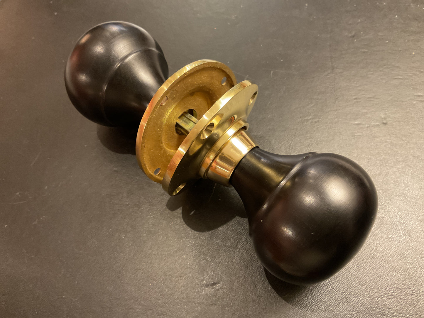 8034B - Ebony Bun Door Knobs On Polished Brass